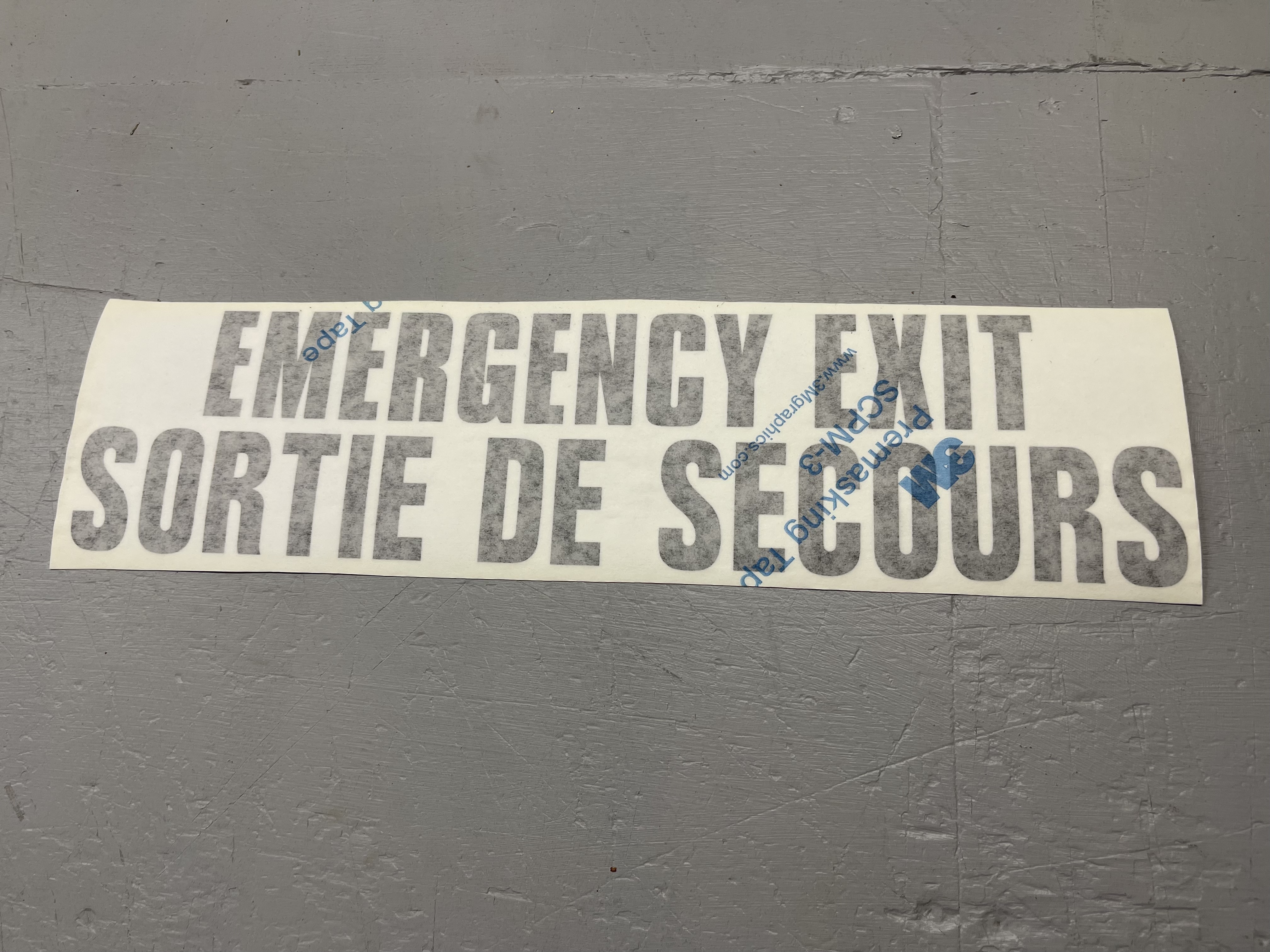 DECAL,EMER EXIT,BIL,BLK TRANSF