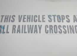 DECAL,STOPS AT RAIL,BLK TRANSF